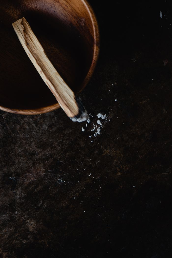 services-04 Burning Palo Santo in a wooden bowl for spiritual cleansing and purification.